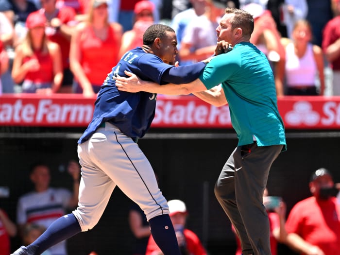 Jun 26, 2022; Anaheim, California, USA; Seattle Mariners strength coach James Clifford holds back center fielder Julio Rodriguez (44) during a benches clearing brawl with the Los Angeles Angels in the second inning at Angel Stadium.